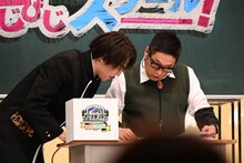 団長先生（右）の進行を手伝うタカシ。