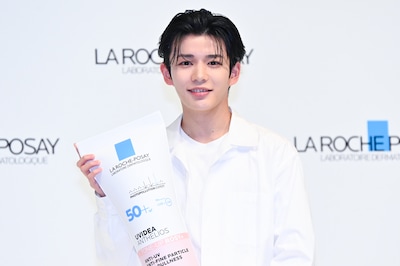 ラロッシュポゼの巨大ボトルを手にほほえむ長尾謙杜。