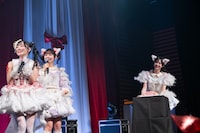 岸みゆへのサプライズでステージ上手からバースデーケーキを運び込む神南りな（右）。