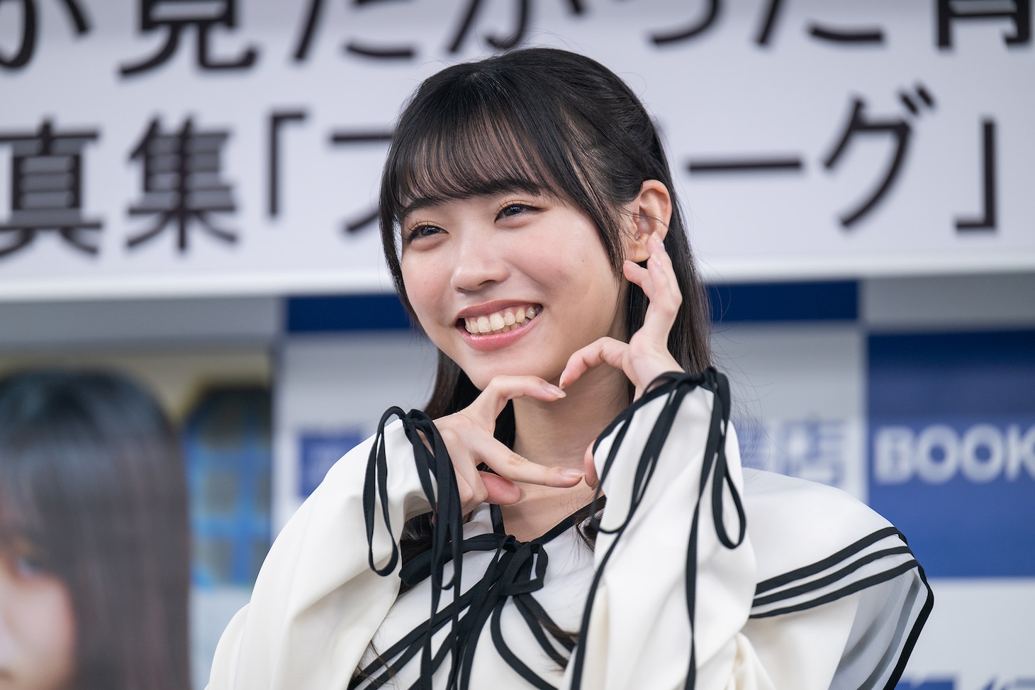 自身がセンターを務める楽曲「あれはフェアリー」の“フェアリーハート”ポーズを決める金澤亜美。