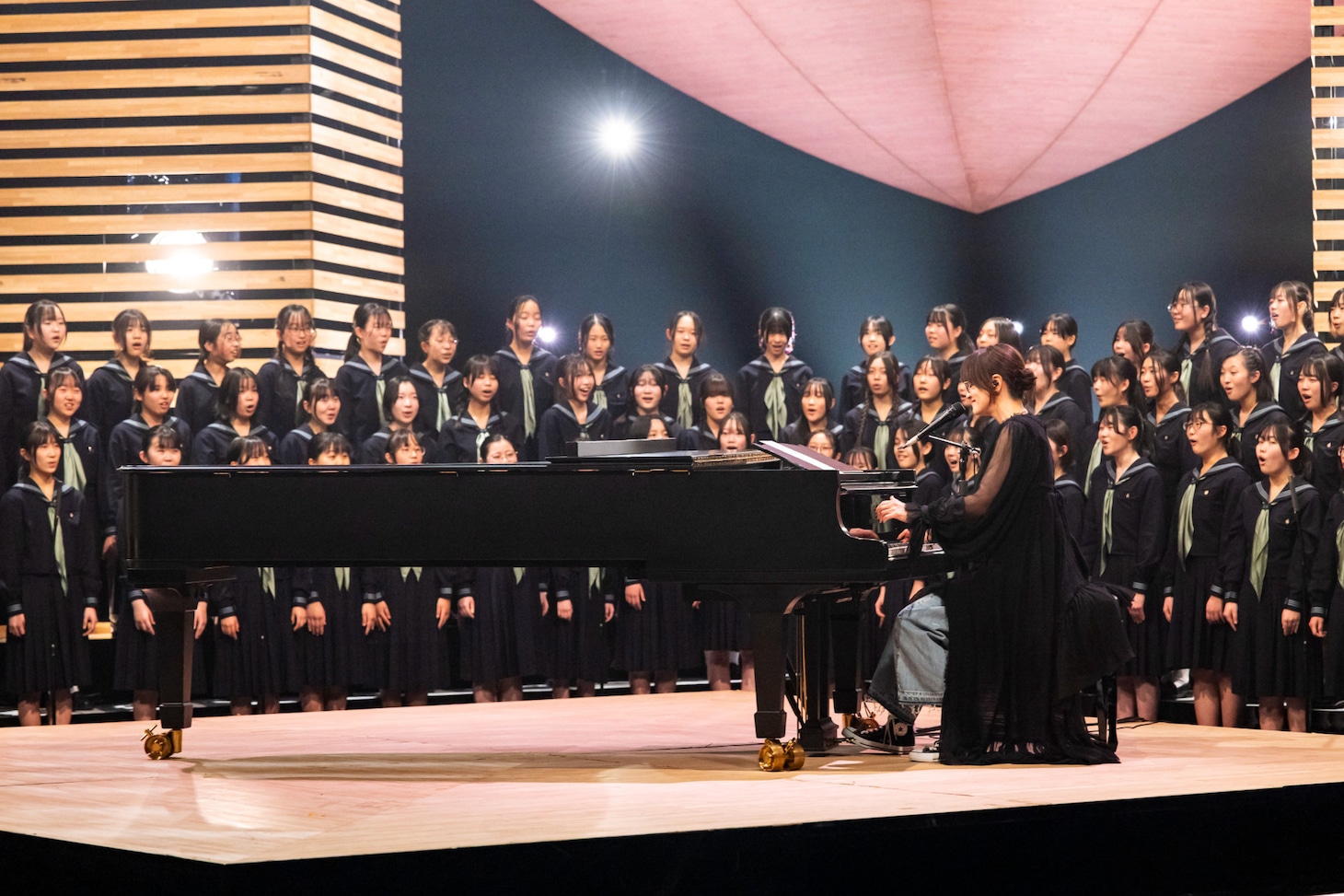 中学校の合唱部員86人と「手紙 ～拝啓 十五の君へ～」を歌唱するアンジェラ・アキ。©︎NHK