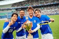 トロフィーを手に笑顔を浮かべる福西崇史、坪井慶介、柿谷曜一朗、安田理大（左から）。