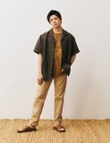 グラフィックTシャツにヨーロピアンリネン100％のブラウンシャツを着用する岸優太。