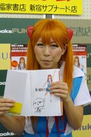 直筆サイン入りの書籍「桜・稲垣早希のブログ旅 完全補完計画～関西縦断＆四国一周編～」を持つ稲垣。