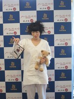 DVD「パーフェクト・ホスト 悪夢の晩餐会」を持つというよりつまむ鳥居。