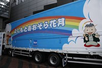 トラックの側面には青空に虹の架かった明るいイラストが。(c)吉本興業