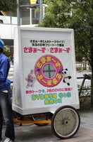 キャンペーン隊の自転車に掲げられた告知ボード。