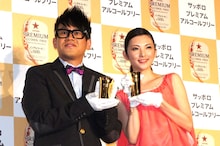 プレゼントキャンペーンで当たる「特製純金タンブラー」を手にフォトセッションに応じる宮川大輔と田中麗奈（左から）。
