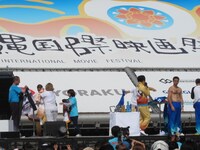 檀上で新デザインのジャージに着替える芸人たち。