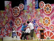 スタジオセットに置かれた白シャツ白ネクタイのマネキンが気になる2人。