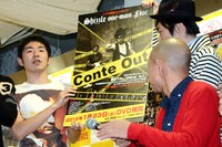 来年発売のDVD「しずる単独コントライブ Conte Out」について告知する、しずる（後方）。