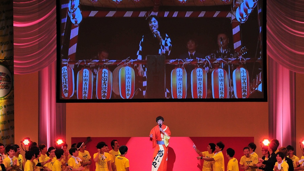 「よしもと夏の大祭り 2014 presented by 5up よしもと」の「よしもと夏の大祭り 2014 グランドファイナル」で河内音頭を披露する河内家上り丸こと銀シャリ・鰻。後ろの画面に注目。