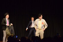 ファンに向かってポーズを決めるマツモトクラブ（手前）と着替えを手伝う湘南デストラーデ。