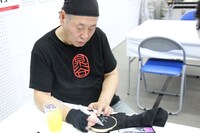 パンツにサインを入れる泉谷しげる。