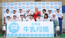 酪農家の人々と写真を撮るメイプル超合金。