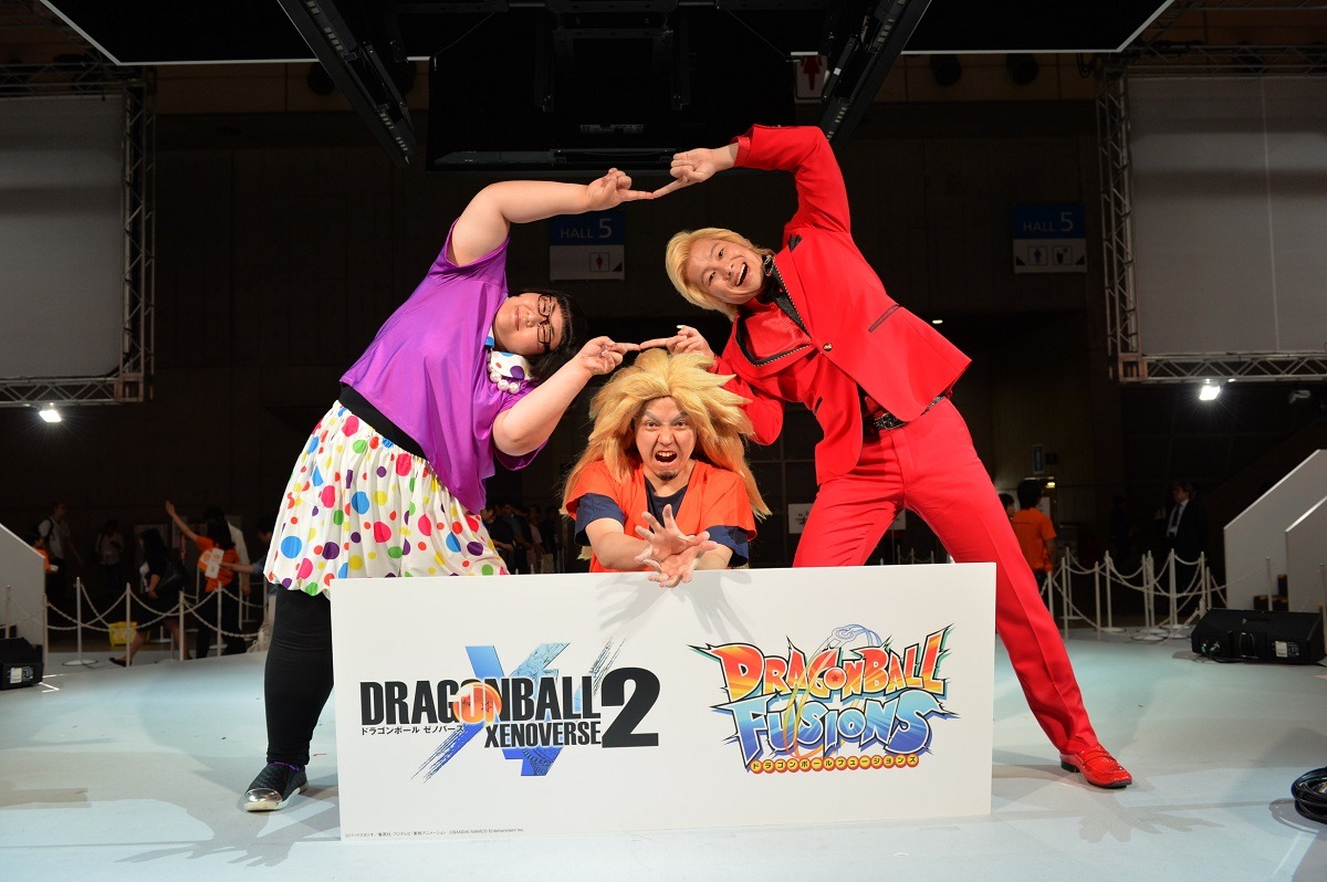 ゲームプロデューサー・平野真之氏の後ろで「ドラゴンボール」の合体技「フュージョン」のポーズを決めるメイプル超合金。