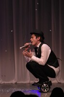 パーソナルモビリティに乗りながら熱唱する木崎。