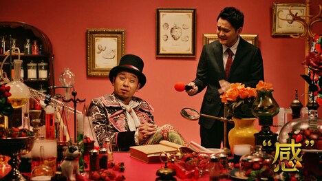 千鳥・大悟扮するパティシエの兜芋（左）とリポーター役の千鳥ノブ（右）。