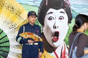 小道具の扇子を持つコウメ太夫。