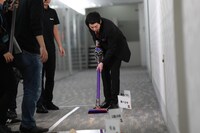 掃除機の吸引力を試す今田耕司。(c)テレビ朝日