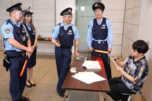 NON STYLE井上（右）が「大喜利警察」に職務質問されるワンシーン。(c)フジテレビ