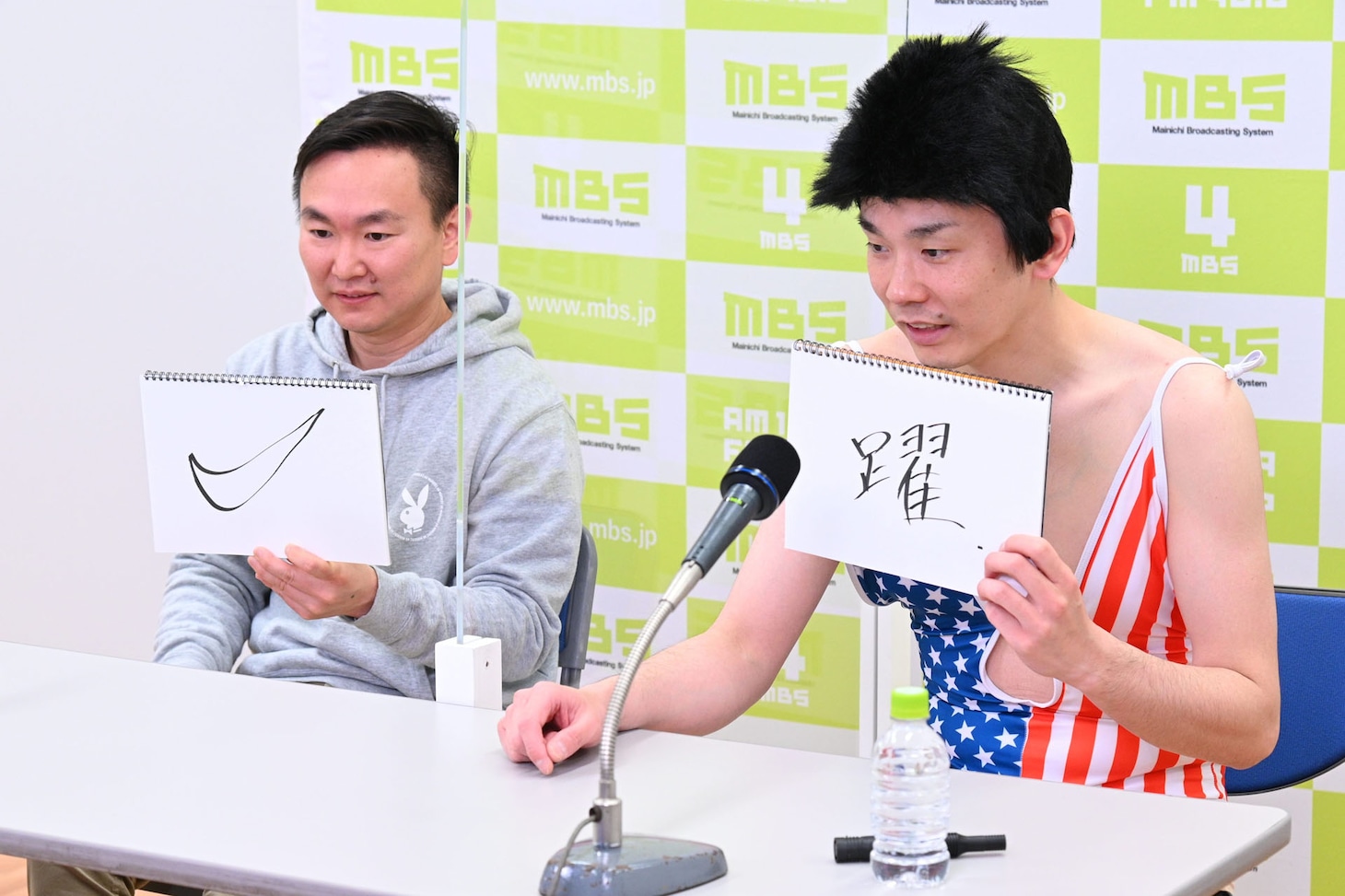 今年の自分たちを表す“漢字”を披露。山内は右肩上がりを表現。実は「飛」という漢字も書いていて、打ち合わせなしにもかかわらずコンビで「飛躍」となった。(c)MBS