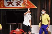 「斉唱」のやり方に不安が残るひょっこりはんに「ばっちり」サインを出すもう中学生（左）。