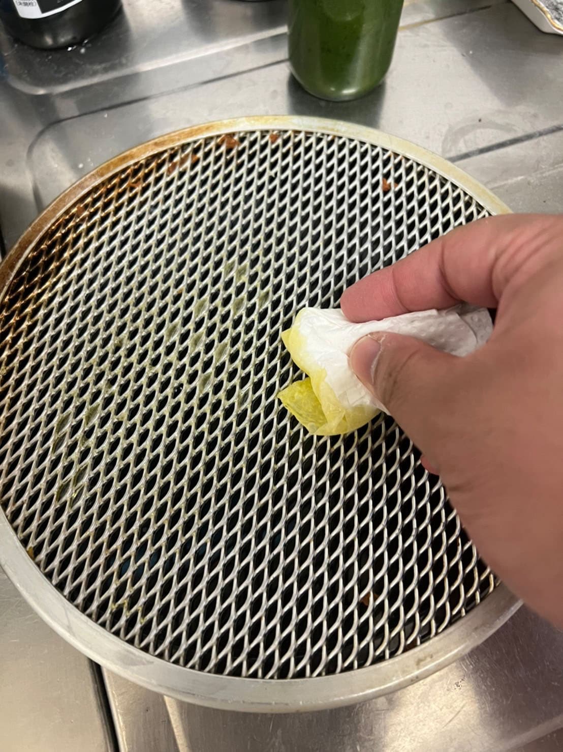 ピザ網にオリーブオイルを塗る大鶴肥満。