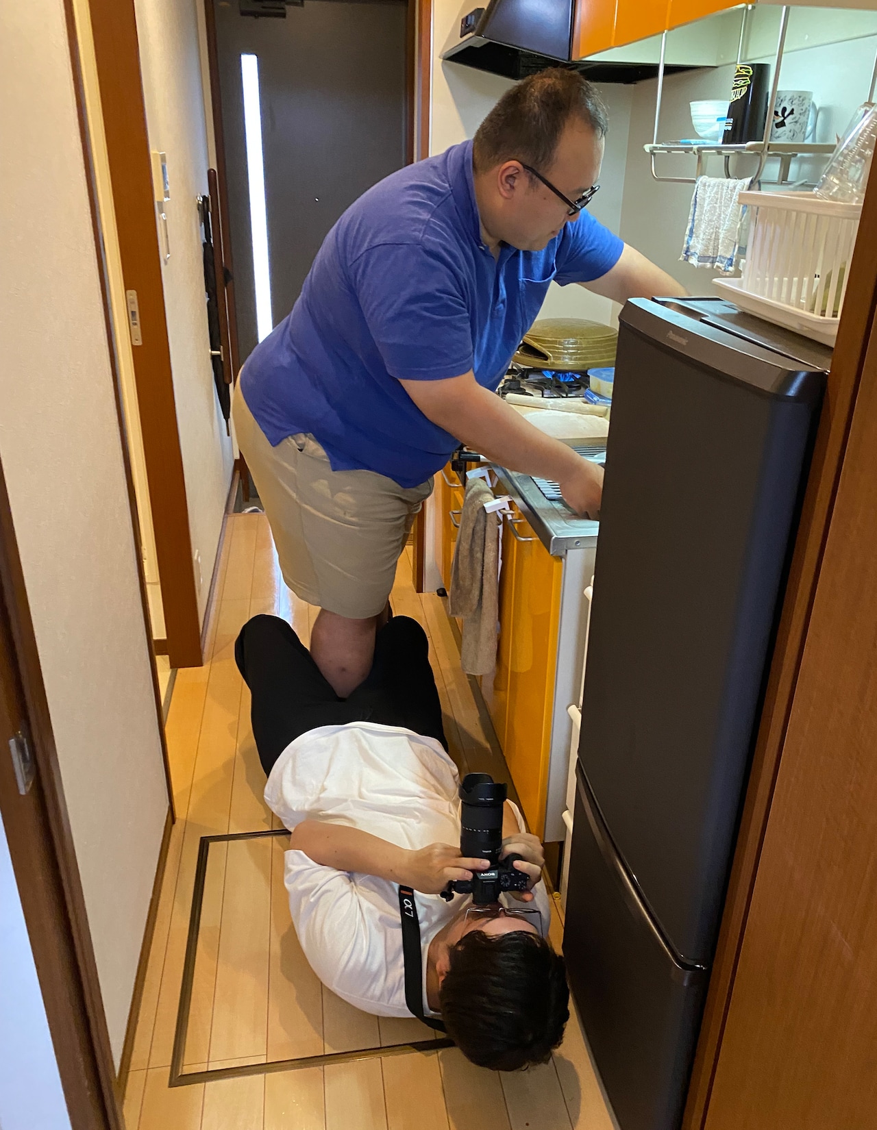 ピザ作り中の大鶴肥満さんを下から撮る檜原洋平さん。