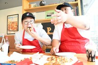 ドミノ・ピザのおいしさを力説する肥満さん（右）。