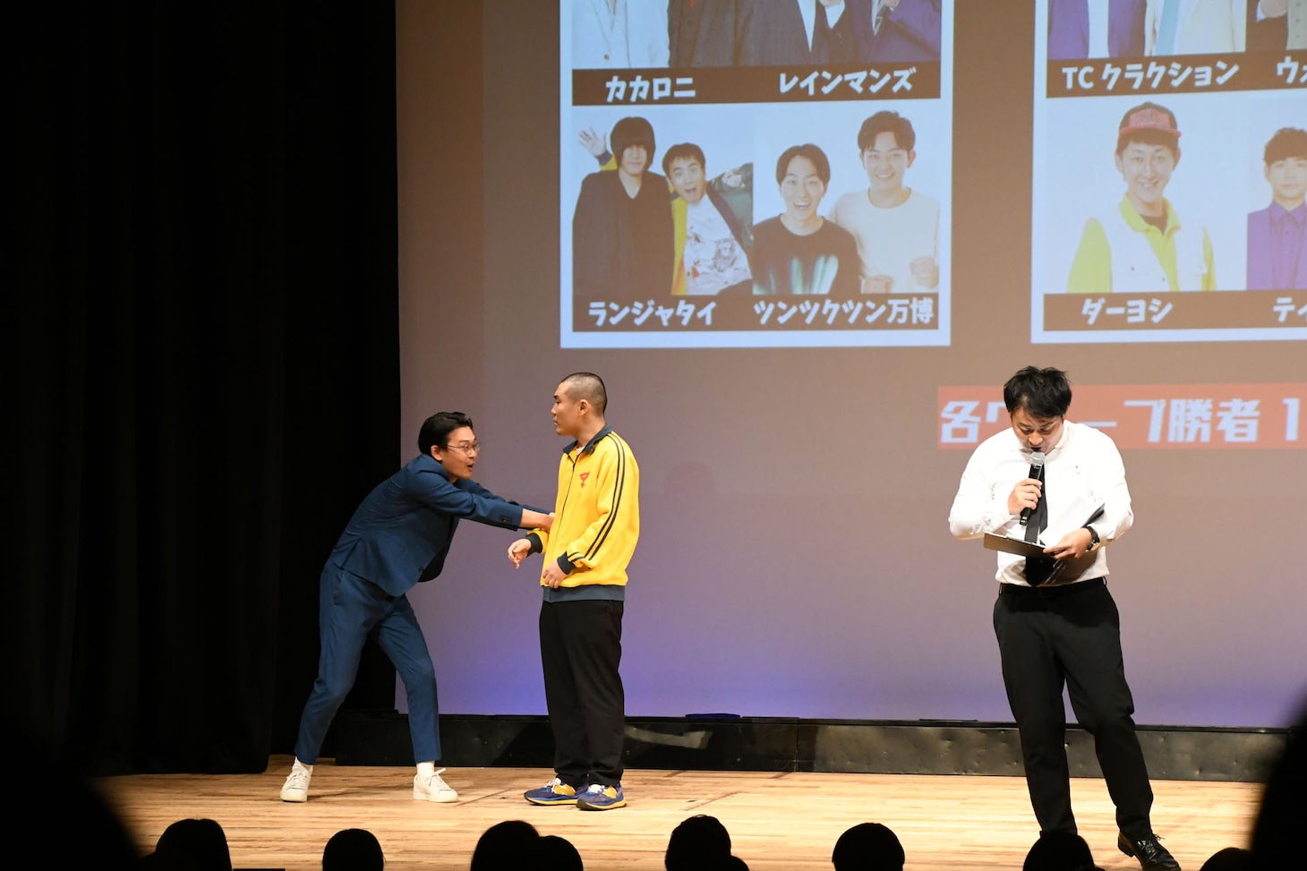 なかなか舞台からはけないランジャタイ国崎（中央）と、構わずMCを続けるトミドコロ（右）。
