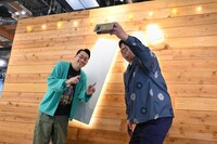 「バ」の看板の前で記念撮影するバナナマン。