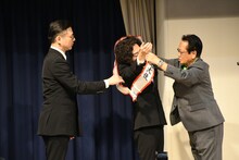 井澤邦夫市長に大使のたすきをかけてもらうガクテンソクよじょう。