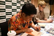 「書籍!!今月のお笑い」にサインを入れる井口