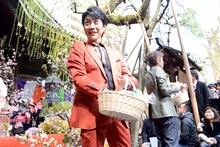 餅まきをする野村萬斎。