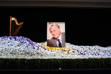 「浅利慶太 お別れの会」より、祭壇に飾られた劇団ロゴマークのモチーフ・ハープ（左）と、浅利慶太の遺影（中央）。