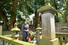 墓前で手を合わせる尾上松緑。(c)松竹