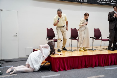 這いつくばって壇上に登る、佐々木心音扮する佐伯伽椰子(左)と、逃げるいしだ壱成(中央左)と大場美奈(中央右)。